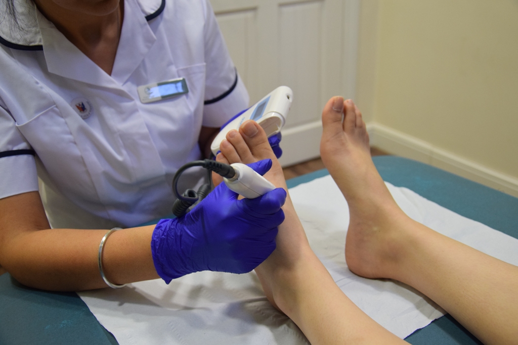 Ruby Kallah podiatrist in Huntingdon assessing a patient with a doppler